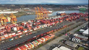 Cinematic 4K drone footage of the supply chain disruption, containers piled high, empty containers, unloading on the West Coast at the Port of Tacoma, Pacific Northwest in Washington
