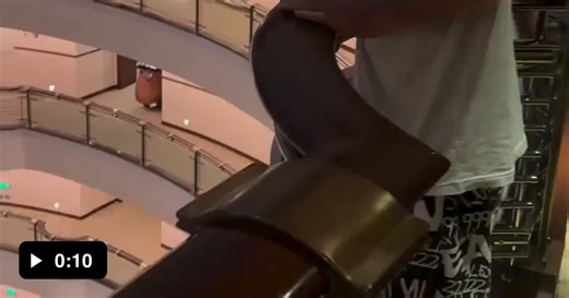 POV looking down from the upper floors of this hotel - Video