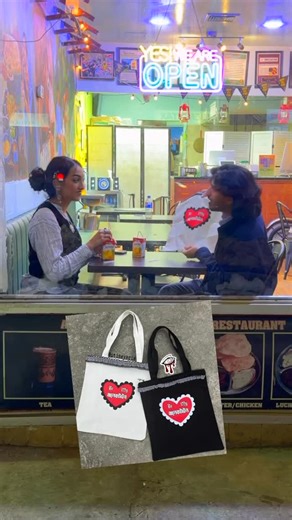 eyeris on Instagram: "“Be My Baalertine” Valentine desi fusion tote bag with chained jhum(ka). Limited quantity available in black/white. 15inx14in tote bag comes with hand-charmed zipper and Bangladeshi intra/inter generational hand-picked sourced n stitched lace trimming. Message to order for you or your loved one(s)! (NYC link/international shipping available) ❤️‍🩹A very special dhonnobadh/thank you to @khon_studios + @tawsifakber (& uncle) for directing/editing/filming, @fahim_o___o_ + @mar