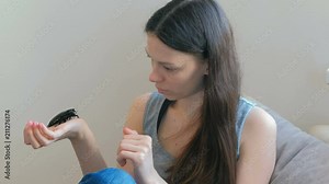 Young woman holding a male of Gromphadorhina portentosa the hissing cockroach, one of the largest species of Madagascar cockroach.