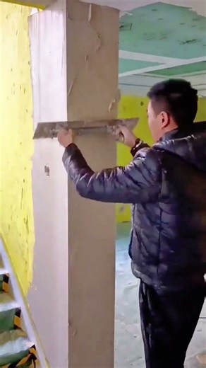 Precise wall plaster smoothing work to achieve a clean and even interior surface finish