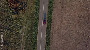 Moving Car, aerial. Aerial shot of a moving car on the countryside highway. Aerial view of a car driving on a road in a fields. Electric transport, ecological. Non-polluting electric car.