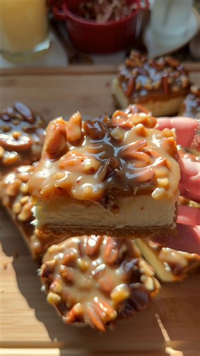 GRANDMA’S SOUTHERN PECAN PIE CHEESECAKE BARS These PECAN PIE CHEESECAKE BARS taste like the holidays at Grandma’s house—creamy, nutty, and sweetly Southern. With a buttery graham cracker crust, a rich cheesecake center, and a gooey caramel pecan topping, every bite feels like a warm family memory shared around the dessert table. INGREDIENTS For the Crust: 1 3/4 cups graham cracker crumbs (about 18 sheets) 1/4 cup (49g) granulated sugar 1/2 cup (113g) unsalted butter, melted For the Cheesecake La