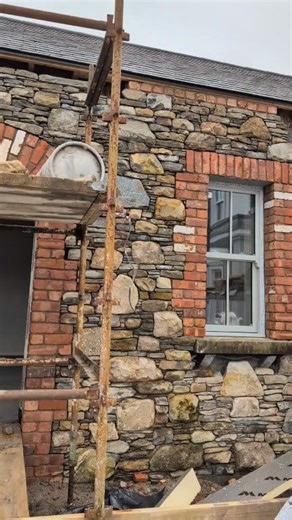 Scaffolding tomorrow to finish this big build. I'm really looking forward to getting the rest of the scaffolding down to see it probably. It takes another form when the daylight gets into it with shadows and depths. That's when stonemasonry really comes to life. The stone is Limestone,granite, sandstone and liscannor. All reclaimed of and old building Supplied by Paddy Carroll Coole Stone @top fans #selfbuildni #buildingstone #tradesmen #StoneMasonry #tradional #architecture #stone #construction