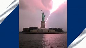 Statue of Liberty lit up by lightning