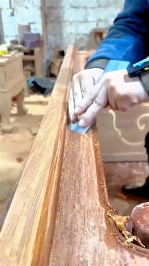 Carpenter Using a Specialized Hand Plane to Create a Smooth Curved Profile in Large Timber