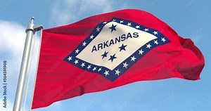 Arkansas flag on a flagpole waving in the wind in the sky. Wonderful intro for your projects. State of Arkansas in The United States of America. Little Rock.