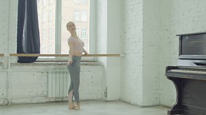 Ballet dancer warming up holding a pole - Free Stock Video