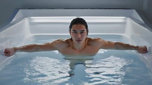 Download A stark and artistic full-body shot of a person in an ice bath, with their muscles tense and their face showing raw endurance for free