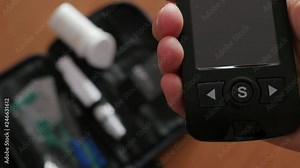 inserting strip measuring level of glucose blood in glucometer, glucose meter