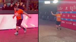 People clap and cheer as the final runner crosses the finish line at the London Marathon