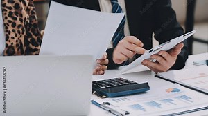 Business meeting time. Photo young account managers crew working with new startup project. Notebook on wood table. Idea presentation, analyze plans. Wide,film effect