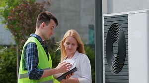 The specialist explains to the customer the principle of operation of the heat pump | Premium Stock Video Footage