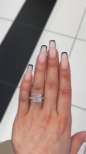 Excellent cut, polish and symmetry and is set in a classy side stones hidden halo setting in real, solid 14K gold. Classic claw prongs and a delicate basket setting securely cradle the center, allowing it to shine with maximum brilliance. This gorgeous ring showcases a breathtaking 5 carat princess-cut diamond and features a hidden diamond halo. The band is masterfully set 3/4 of the way around with beautiful pavé lab-grown diamonds, completing the simple and elegant, yet eye-catching engagement