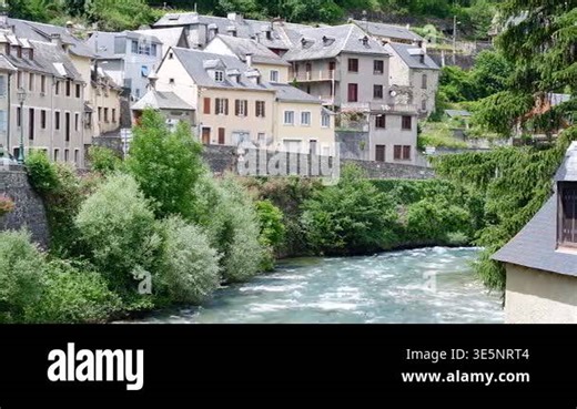 Mountain river flows through Arreau in summer with houses along the banks Stock Video Footage - Alamy