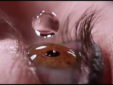 Eye drops slow motion close up