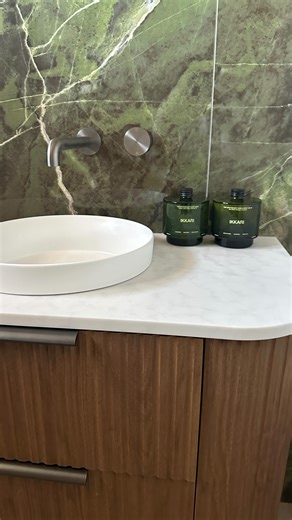 Erin | Lifestyle content creator on Instagram: "Goodbye 70s blue tiles and spray painted shower frame, hello moody dream bathroom ✨ My bathroom lacked style and function, with a children-sized bath and a cluttered space. So I transformed it into dark green marble vibes. I love the wooden finish of the floating vanity from @marquisaus and how that elegance is carried through to the gun metal hardware from @nerotapware. It’s now my favourite room in my home 💕 Watch until the end. The transformati