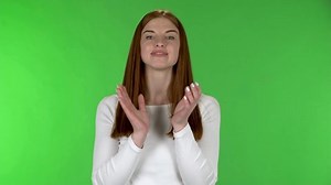 Portrait of pretty young woman is clapping her hands indifferent.
