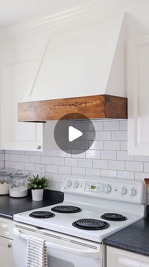 Angela | DIY + Design on Instagram: "Our range hood went from an eye sore to a beautiful focal point of the kitchen by installing a new range hood with buttons on the bottom and a DIY range hood cover. Get the DIY range hood cover tutorial and link to the range hood I used in my stories or on my blog! This is one of my all time favorite DIY projects that cost less than $200 total for the range hood and DIY cover! #rangehood #rangehoodcover #kitchendesign #diykitchen #diyprojects"