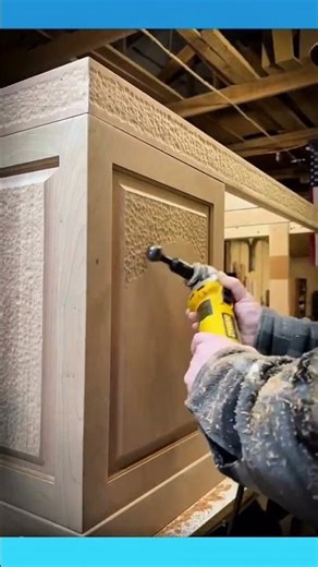 Creating decorative patterns on a wooden cabinet by carving small chip details into the surface.