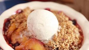 Sweet peaches, blueberries and a buttery crisp topping are all baked up into my Peach and Blueberry Crisp recipe. Easily bake it anytime: http://bit.ly/peachblueberrycrisp | Bigger Bolder Baking