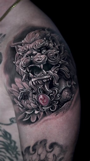⚜️ The Foo Dog, also known as the Chinese guardian lion, symbolizes protection, strength, and power. It is traditionally placed at entrances to guard against negative energy and evil spirits. Often shown in male and female pairs, it represents balance, protection of the home, and harmony. #realism #tampatattooartist #blackandgreytattoo #foodog #crisantemo