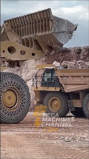 Massive Wheel Loader Loads Heavy Rocks On Powerful Dumper