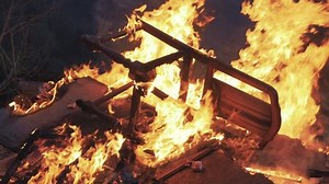 Detail of a furniture bonfire, wooden chair on flames. 4k