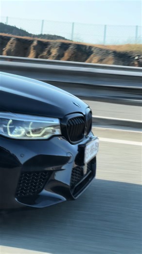 Sleek Black BMW on Highway: A Modern Driving Experience
