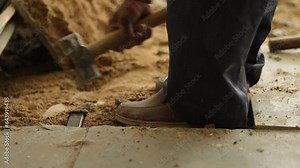 Architecture tile removing. Tiles Removing. Worker is removing broken tiles. Cleaning the tiles aside. Construction worker working hard, using hammer and chisel.