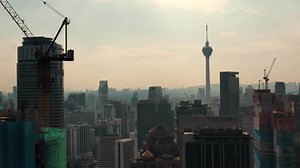 Download Drone Aerial view 4k Footage of Kuala Lumpur city skyline on sunset in Malaysia. for free