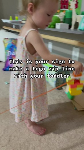 Fun game to play with your toddler! Create a little zip line with a ribbon or string and build a Lego character to slide down! Have fun! #lego #zipline #toddlerlife #toddlermom #kidsactivities #fun #games | Lily b Coco - Silly Miss Lily From Paisley's Corner