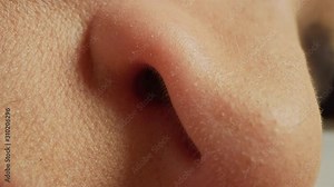 Close Up Macro Zoom Shot of a Nose. Young Beatiful Female Lightly Breathing while Sleeping. Nose Moving in Sync with Breathing Air. Bialogical Macro Shot of Facial Freatures.