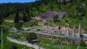 Apollo Temple in Delphi with a stunning aerial reveal by a smooth dolly shot pulling out shot, Greece.