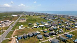 Aerial video neighborhoods with stilt homes Bolivar Peninsula Texas