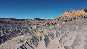 Mudstone formations of steel blue wavy sharp rocks ridges western Usa. Factory Butte canyon towering of wonder foothills. Aerial view over rugged terrain dunes structure carved riverbed by erosion