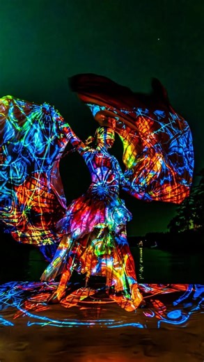 Chrysalis Silk Studies | learn silk fans online on Instagram: "A sneak peek of my late night light show solo at @imagineorcasisland thanks to the beautiful light projections by vjkaizen… more to come! You can learn this move I call ✨Cross Body Weaves✨ in Level 2 of my online silk fan school. You know where to go to get there 😉 #chrysalissilkstudies #silkfantutorial #silkfans #veilfans #flowartist #flowartists #gotflow #flowstagram #thebamboocloset #silkfanflow #fanveil #fanveils"