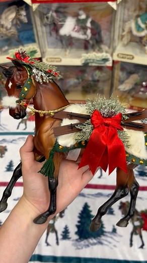 Let's unbox the 2024 Breyer Holiday Horse, Après Ski! 🎿This gorgeous bay warmblood is decked out in faux fur, greenery, bells and ribbons - and of course, a pair of skis for hitting the slopes. The Breyer Holiday Horse has been a yearly tradition for horse lovers and families since 1997, and we're proud to add this gorgeous piece as the 28th edition in the series. 🥰 Find the Après Ski model and gift products as part of the Breyer Holiday Collection on BreyerHorses.com! | Breyer Model Horses
