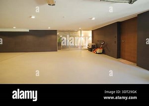 Spacious garage storage cabinets bikes with epoxy floor and warm overhead lighting, organized tool cabinets and bicycle racks Stock Video Footage - Alamy