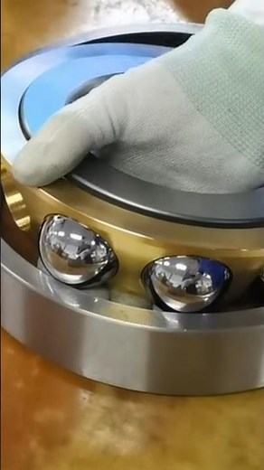 Manual process of inserting balls into bearings