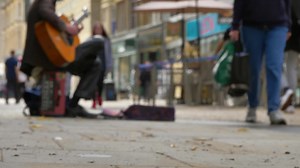 Free stock video - Low angle shot of busker on busy street in oxford 02