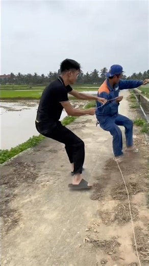 Two kite flyers pulled their kite up into the air, but a strong gust of wind almost blew it into ...