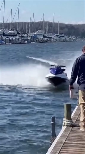 Jet Ski Slams Into Marina Pier After Rider Loses Control Lake of the Ozarks, Missouri Video captured along a busy marina boardwalk shows a jet ski operator losing control while traveling at high speed parallel to a wooden pier. The scene unfolds on a clear afternoon with boat slips lining the shoreline and pedestrians standing along the dock. As the personal watercraft approaches the pier, it appears to veer slightly off course. Despite visible spray from the throttle, the rider is unable to cor
