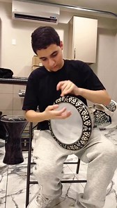 😮"The White Pearl Shield" by Arab Instruments is a Sombaty Plus Darbuka like no other. Heavier than the standard model, it boasts an extra aluminum layer for powerful "Doom strokes" and precise tuning with 8 pegs. Handcrafted in Egypt, its body features premium aluminum adorned with rare Japanese white pearls, giving it a stunning marble-like shine. To elevate its allure, vibrant blue pearls from New Zealand and Australia add a splash of elegance. This darbuka is a masterpiece of craftsmanship,