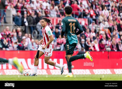 KOELN, GERMANY - APRIL 12: Jahmai Simpson-Pusey (1. FC Koeln, 22) controls the ball against Justin Njinmah (SV Werder Bremen, 11) during the Bundesliga match between 1. FC Koeln vs. SV Werder Bremen at Rheinenergie-Stadion on matchday 29 of the 1. Bundesliga on April 12, 2026 in Koeln, Germany. DFL REGULATIONS PROHIBIT ANY USE OF PHOTOGRAPHS AS IMAGE SEQUENCES AND/OR QUASI-VIDEO Stock Photo - Alamy