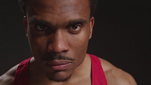 Close Up Portrait Of Serious Male Boxer Wearing Vest Walking Towards Camera And Into Focus Training For Sports Event Against Black Studio Background | Free Stock Video Footage