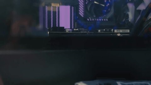 clip-4004517061-fixing-motherboard-inside-computer-case-screwdriver-during