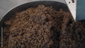 The process of making beer at the brewery. A worker collects raw materials in a vat. Close-up shooting