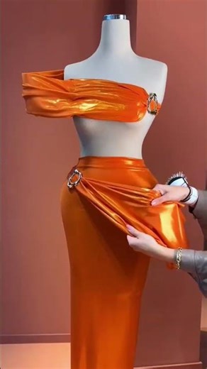 To order this vibrant orange dress DM This sculptural one-shoulder gown is crafted in glossy
