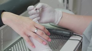 Manicure process in a beauty SPA salon close up. Professional manicurist in gloves paint nails with natural gel polish in luxury salon. Concept nails and hands care